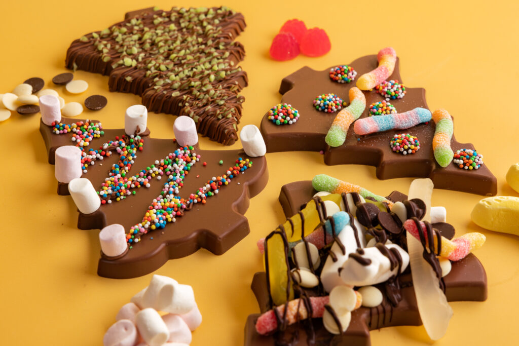 visit the chocolateries for deck the Christmas tree experience in December 2026